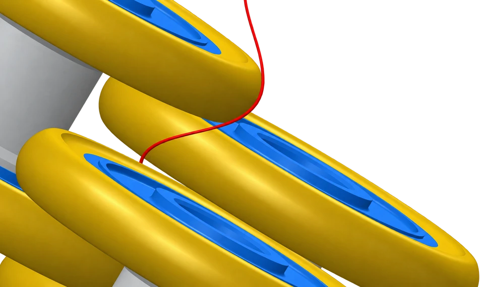 Close up of the red yarn contacting the rounded working edges of the gold and blue friction discs